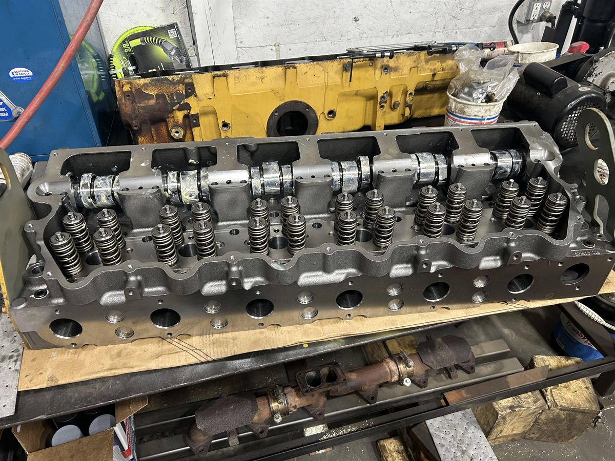 Rebuilt heavy equipment cylinder head and valve train work