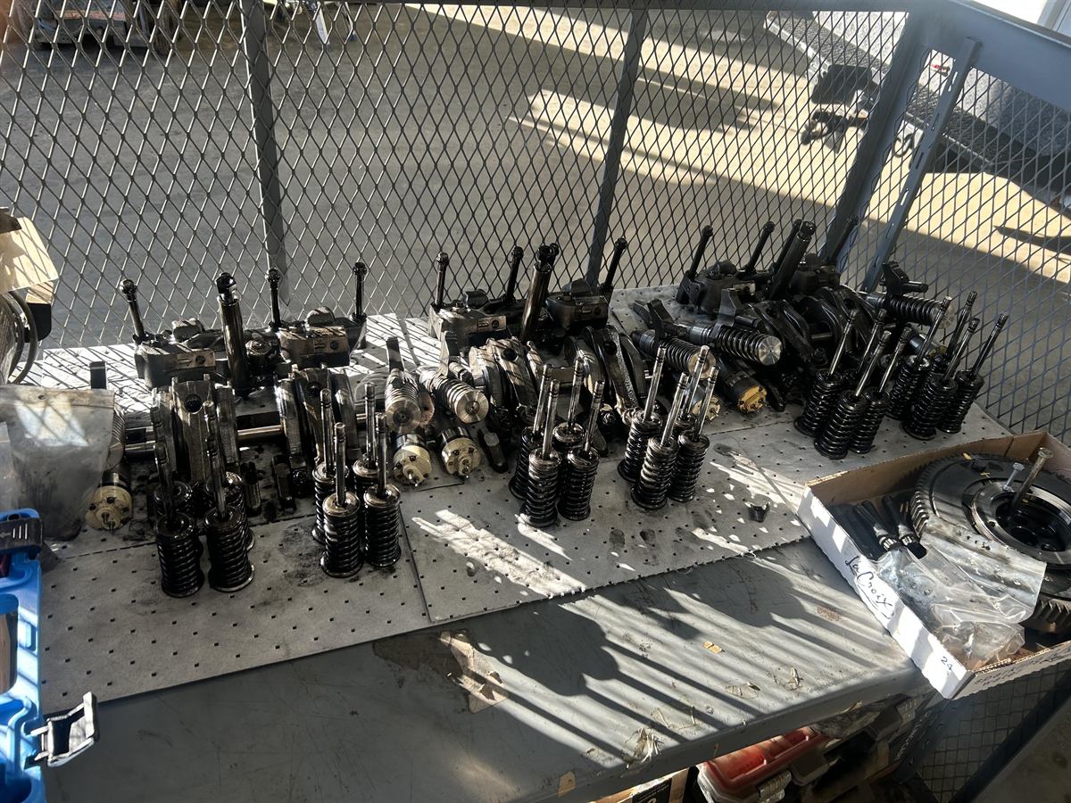 Heavy equipment engine parts and components laid out for repair